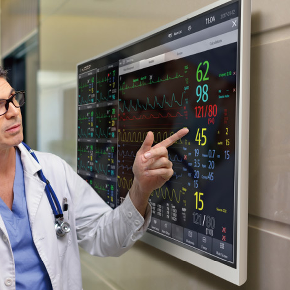 Clinician pointing at vital signs on a wall-mounted BeneVision CMS Vet ViewStation display