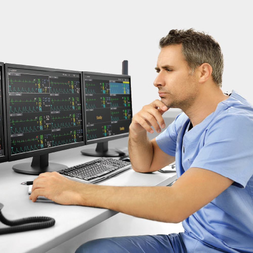 Clinician reviewing multi-patient screens at a BeneVision CMS Vet WorkStation