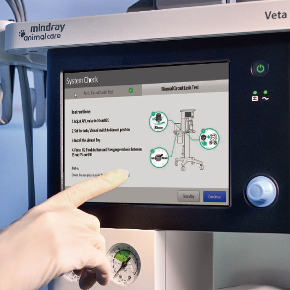 Finger following the leak test instructions on the system check screen of a Mindray Veta 5Plus touchscreen