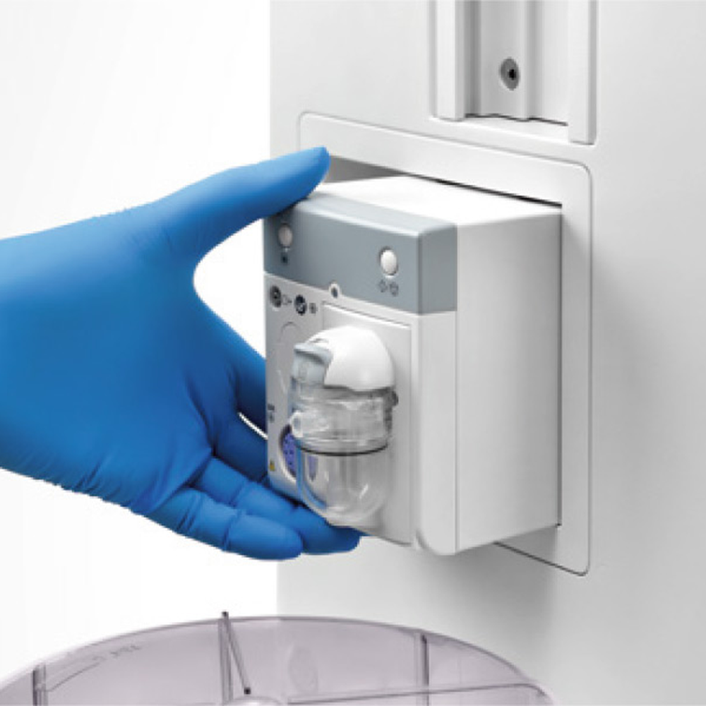 Gloved hand sliding a plug-in gas module into the module bay of a Mindray WATO EX-65 Pro Vet